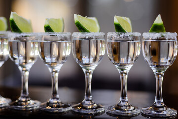 Shots of tequila with a slice of lime on the party