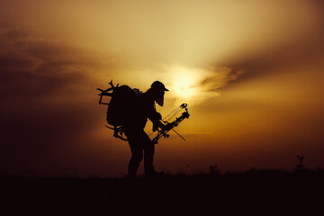 Silhouette of a bow hunter
