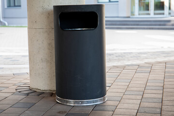 Modern rubbish bin on a street in a public place. Warm and sunny day