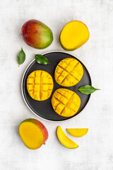Plate of mango fruits and mango cubes. Tropical breakfast. Top view