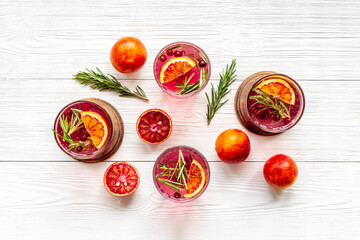 Cold cocktails in glasses with cranberry and blood orange grapefruit