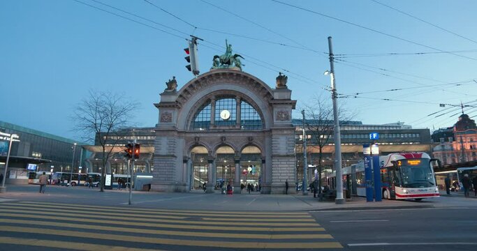 Lucerne, Switzerland - 03 03 2021: train station forecourt by day with Torbogen monument