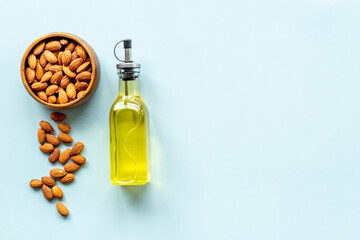 Bottle of almond oil with almond nuts. Extra virgin essence oil