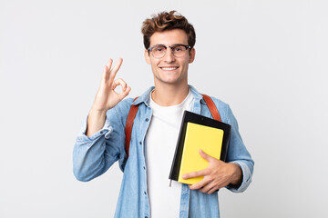 young handsome man feeling happy, showing approval with okay gesture. university student concept