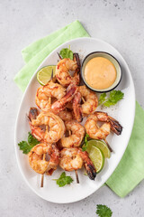 Grilled shrimps. Shrimps skewers, lime and sauce