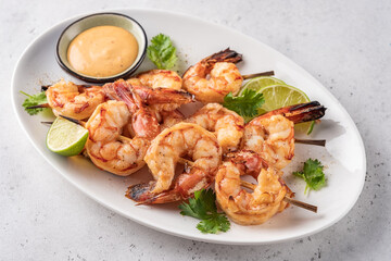 Grilled shrimps. Shrimps skewers, lime and sauce