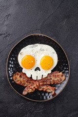 Fried eggs in the shape of a skull. Halloween healthy breakfast