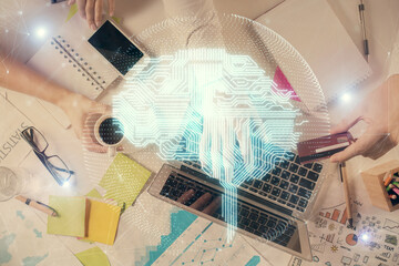 Double exposure of man's hands typing over computer keyboard and brain hologram drawing. Top view. Ai and data technology concept.