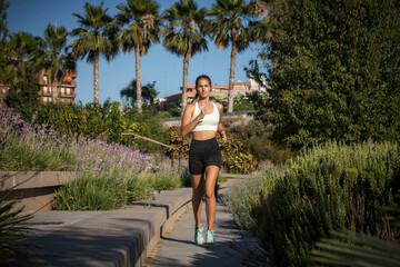 Sporty caucasian girl jogging in a park. Concept runnig