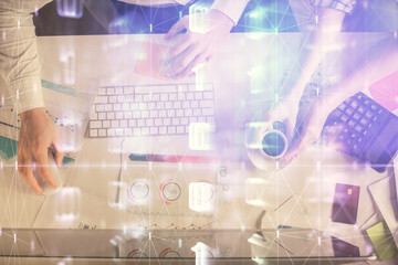 Double exposure of man and woman working together and data theme hologram drawing. Computer background. Top View.