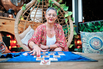 a pythoness woman using tarot cards to predict the future