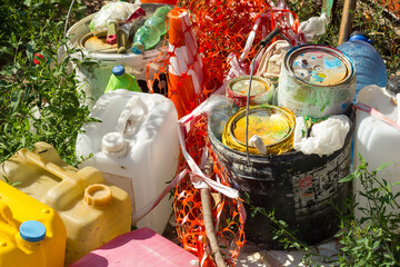 Waste post repair and painting garbage plastic and residues of chemicals lie on the grass,...