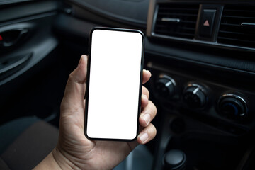Man hand holding  smartphone with blank screen in the supercar.