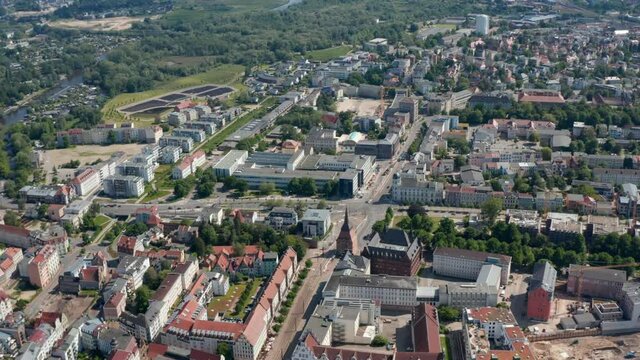 Aerial panoramic view of town. Historic buildings, gabled houses and newer buildings in distance. Road intersection at Steintor town gate