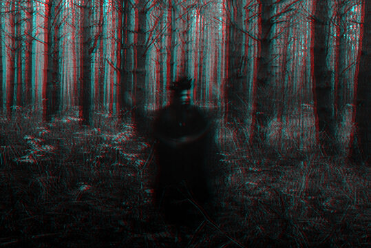 blurry frightening black silhouette of an evil witch casting spells