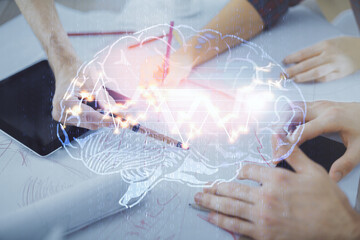 Obraz premium Double exposure of man and woman working together holding and using a mobile device and brain hologram drawing.