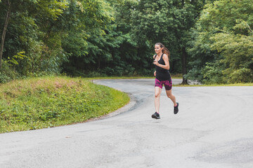 Woman running in the woods. Female runner. Run