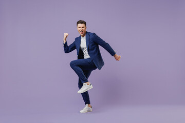 Full size body length young successful employee business man lawyer 20 wear formal blue suit white t-shirt work in office do winner gesture celebrate isolated pastel purple background studio portrait