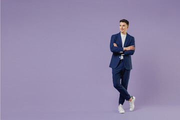 Full size happy young successful employee business man lawyer 20s wear formal blue suit white t-shirt work in office hold hands crossed look aside isolated on pastel purple background studio portrait.