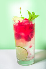 Cherry cocktail on color pink background
