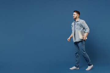 Full size length body side view profile laughing happy handsome young brunet man 20s wear denim...