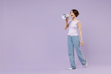 Full length side view young excited woman 20s wearing white t-shirt hold scream aside in megaphone...