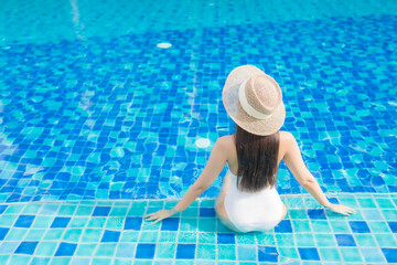 Portrait beautiful young asian woman relax smile around outdoor swimming pool