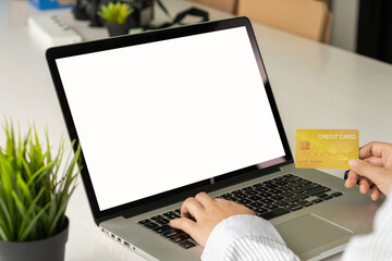 young woman holding credit card and using a laptop computer work at home and online shopping, e-commerce, internet banking,