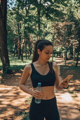 Young woman in sportswear doing exercises in nature. Healthy lifestyle concept.