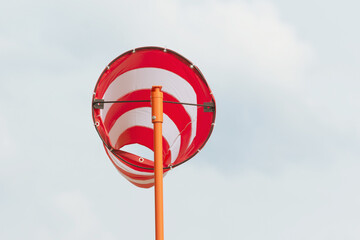 Windmill cone in a airport in storm windy weather.