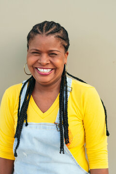 Mature Black Woman Outside The City, Looking At The Camera Smiling.