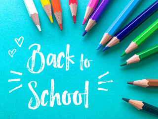 Back to school, color crayons in blue background