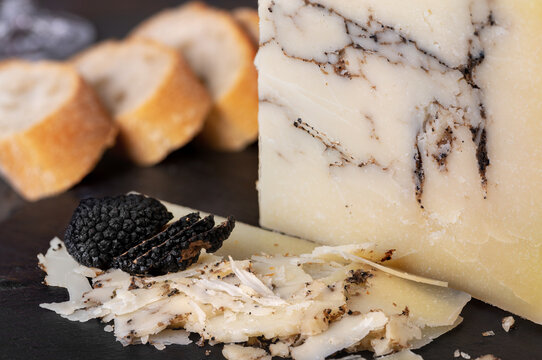 Italian hard cheese Pecorino romano with black truffle