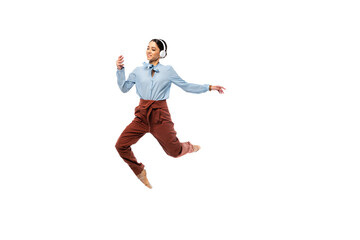 Fototapeta na wymiar Smiling ballerina in headphones using smartphone while jumping isolated on white
