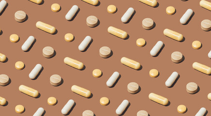 Modern pattern with colorful medical pills on bright brown background. Minimal pharmaceutical backdrop. Trendy earthy colors.