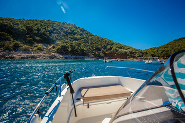 side front of a motor yacht going to the sea towards the mountains. Luxurious travel life. Beautiful view from the boat to the Croatian islands