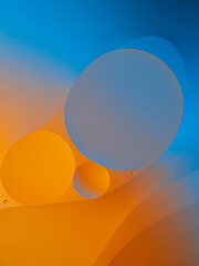 Closeup of oil drops motion on water surface. Colorful abstract macro background of oil drops on water surface with air bubbles inside