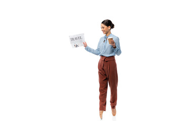 Smiling ballerina holding newspaper and paper cup on white background
