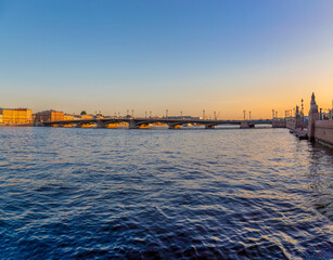 Obraz premium View of the river, panorama of the summer sunset St. Petersburg. Russia. Blagoveshchensky Bridge, Neva River, English Embankment, Sphinxes of the Academy of Arts, Vasilievsky Island.
