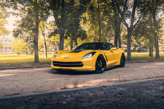 Yellow american muscle car Chevrolet Corvette C7 in the park. Odessa, Ukraine - June 2021.