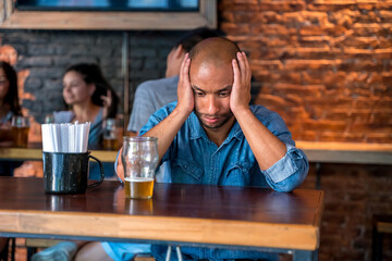 A lonely man sitting at the bar