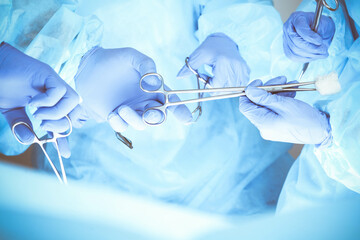 A group of surgeons is operating at the hospital, close-up of hands. Health care concept
