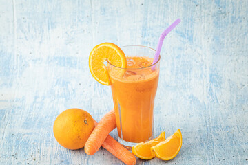 carrot and orange fresh juice on blue table