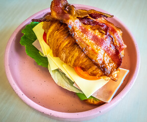 Turkey sandwich on a croissant with swiss cheese