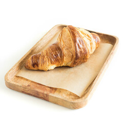 Croissant on a wooden server isolated  .  French breakfast .  Cafe . Menu. 