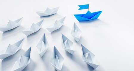 Group of paper boats with blue leader plane on white background