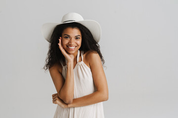 Black young woman in dress smiling and looking at camera