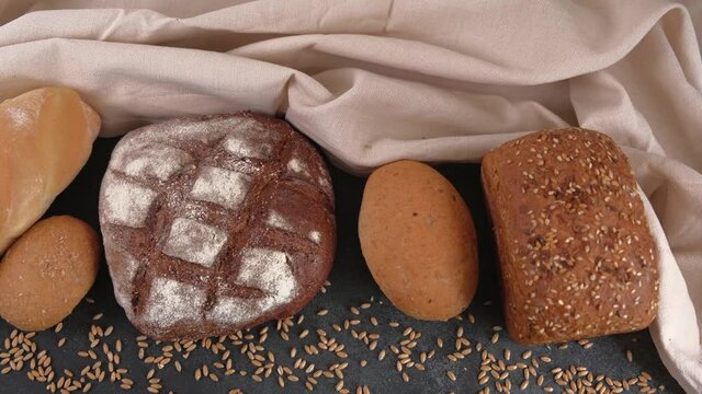 Different kinds of delicious fresh homemade bread loaves and a bun