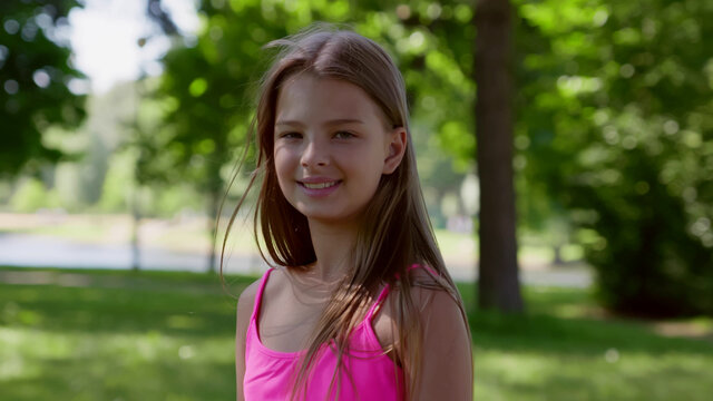 Medium shot of adorable smiling teen girl outdoors