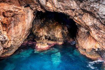rocky cave on the blue crystal clear sea 